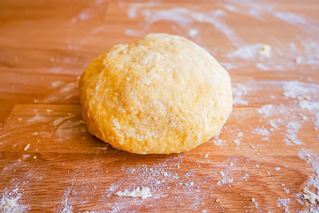 A ball of dough resting on a table.