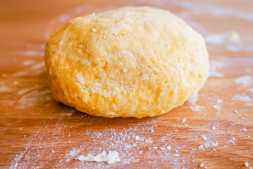 A ball of dough sprinkled with flour.