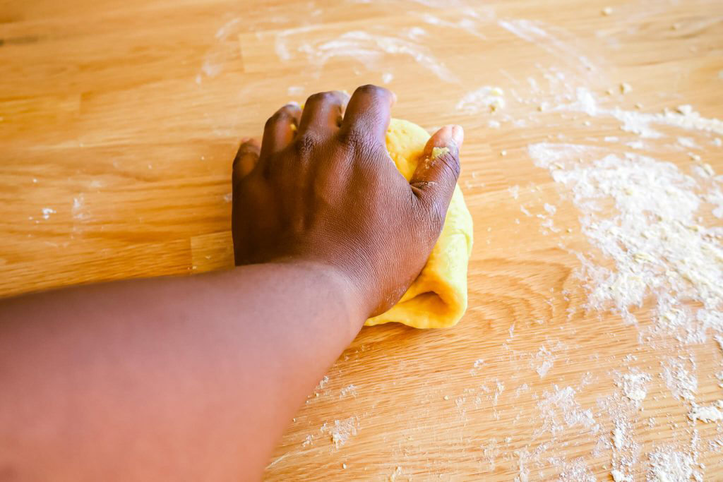 A hand working a ball of dough.