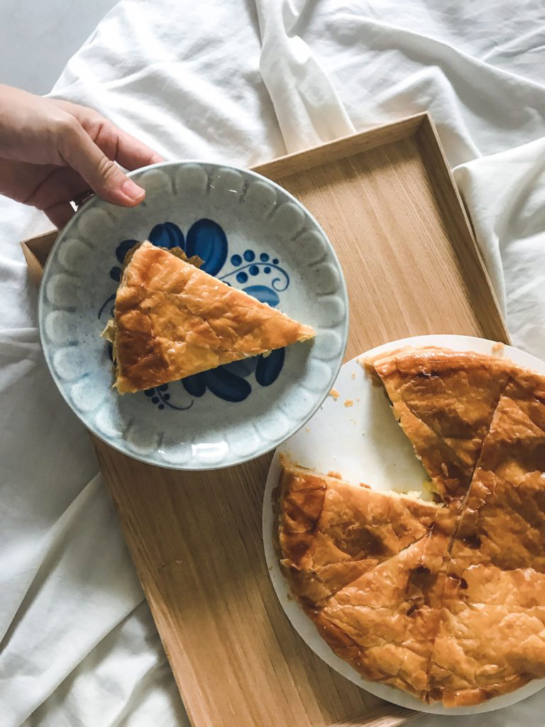 A delicate, blue plate holding a slice of galette des rois.