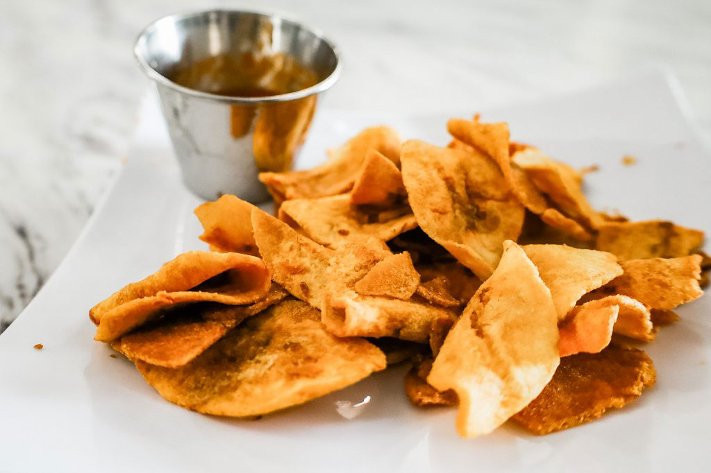 Plantain chips on a white plate.