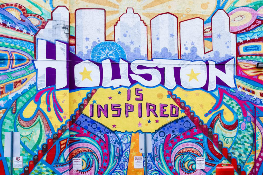 A large, colorful mural that reads Houston is inspired.
