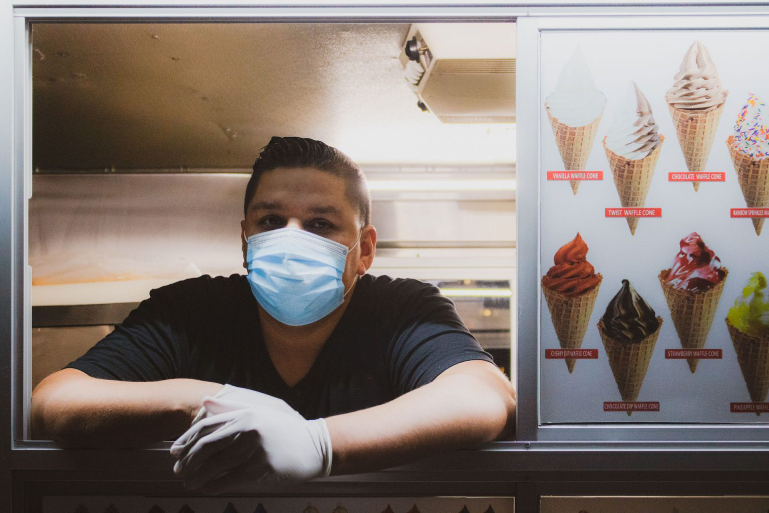 Andy Alvarez patiently waiting for customers inside his ice cream truck.
