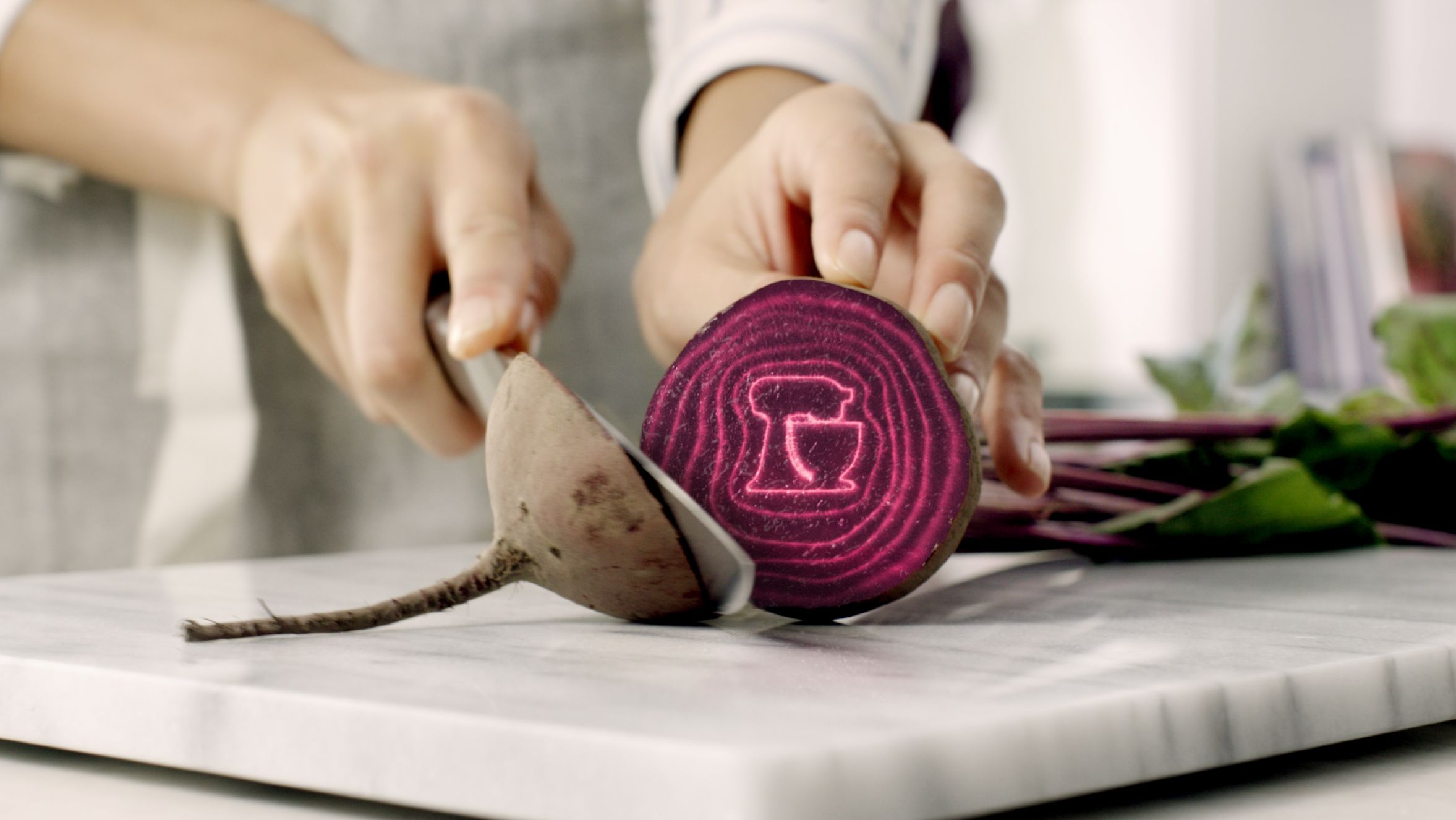 A person cutting into a beetroot.