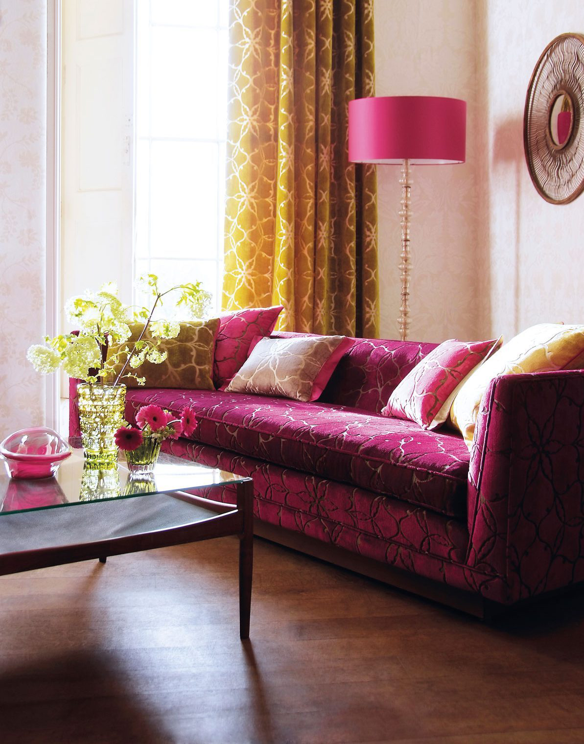 A living room featuring a beetroot colored couch.