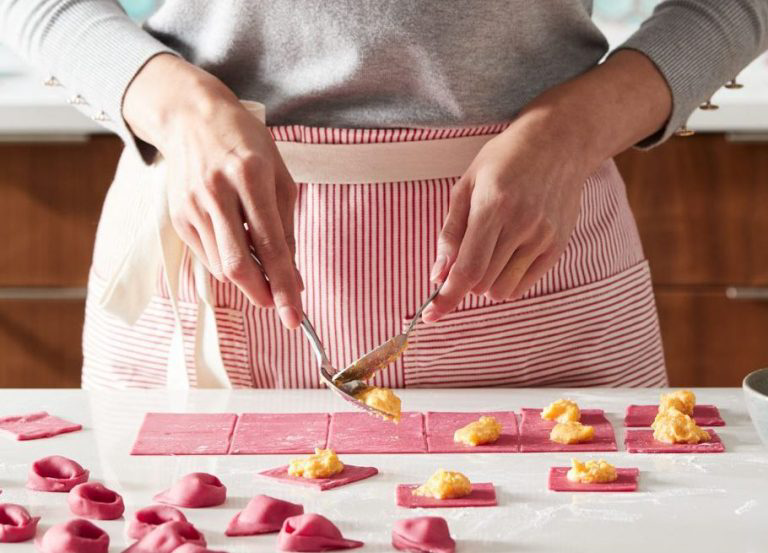 A person making beetroot tortellini.
