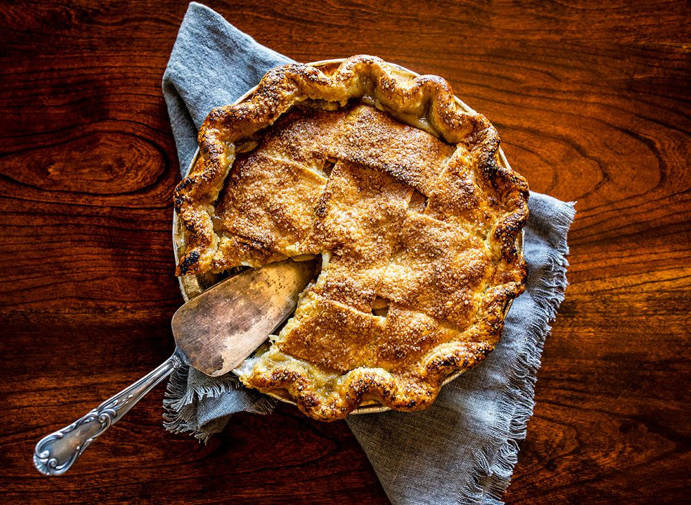 A pie with a serving spoon.