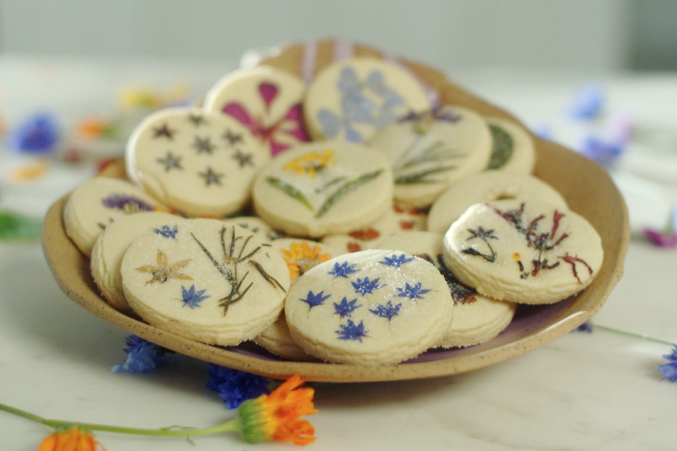 Freshly baked cookies with edible flowers pressed into them