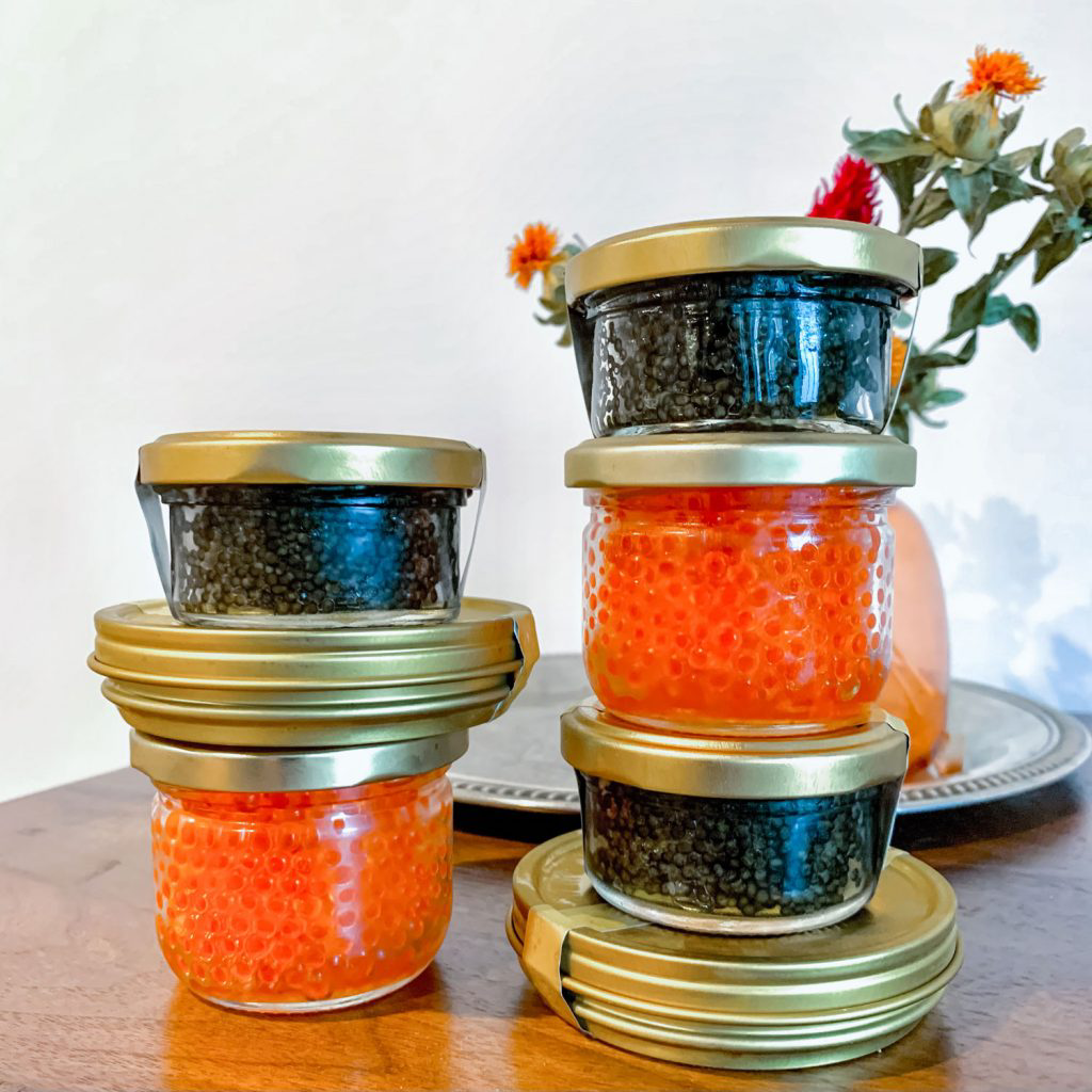 A variety of jars and containers of caviar.