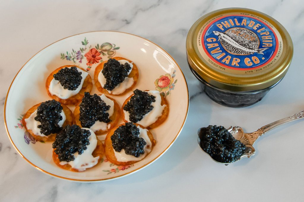 A plate of blinis topped with black caviar.