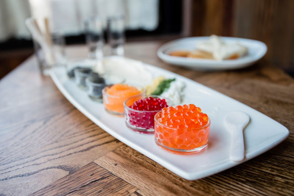 Colorful caviar in glass dishes.