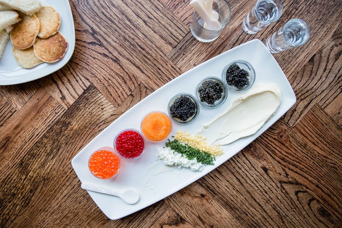 A variety of colorful caviar separated into individual glass dishes.