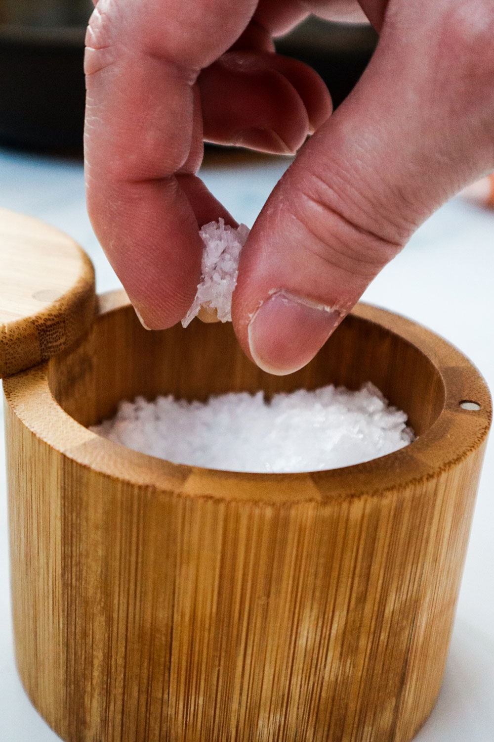 A person holidng a pinch of salt.