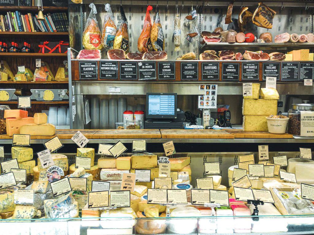 A store displaying a variety of high-quality meats and cheeses.