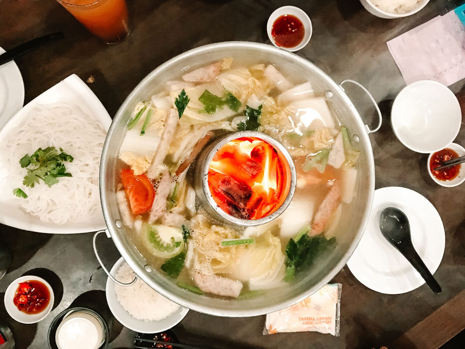 A large non-spicy steamboat in the center of the table.