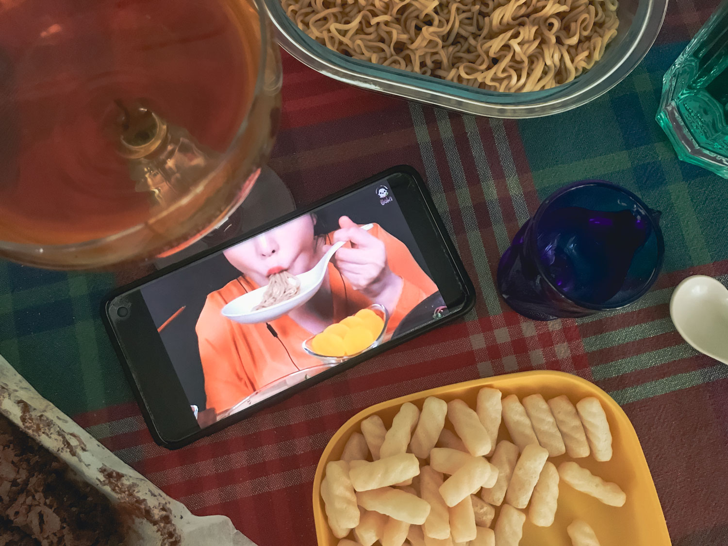 An open smart phone featuring a person eating.