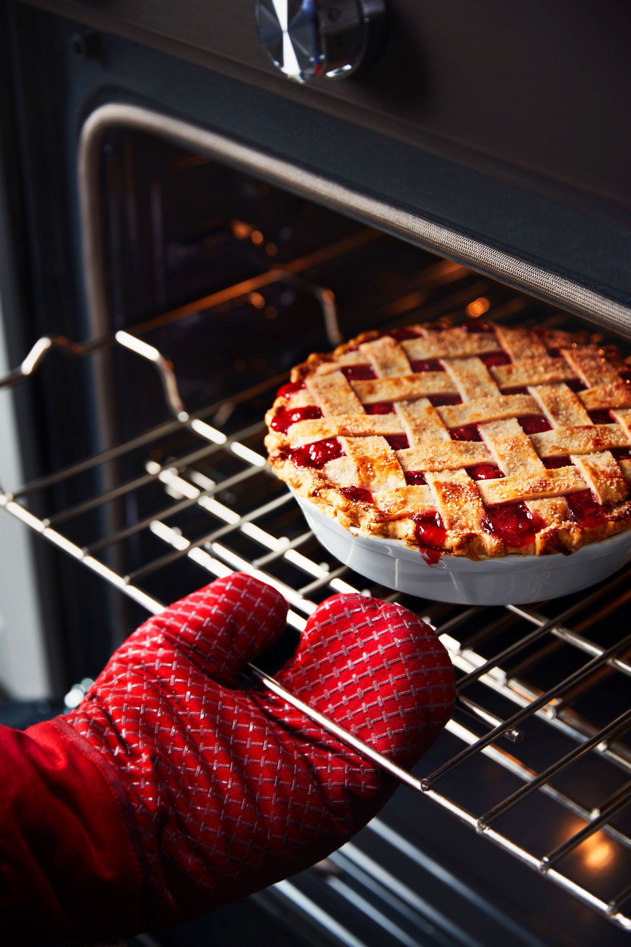 A fresh, flaky pie resting on an oven rack.