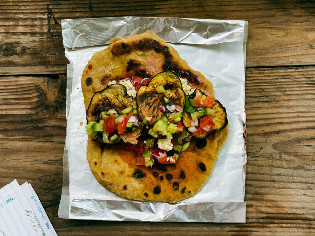 Pita bread topped with sauteed vegetables.