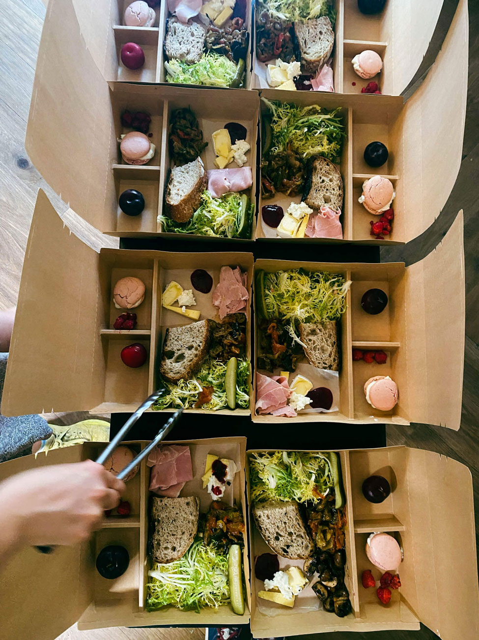 A person putting together picnic boxes.