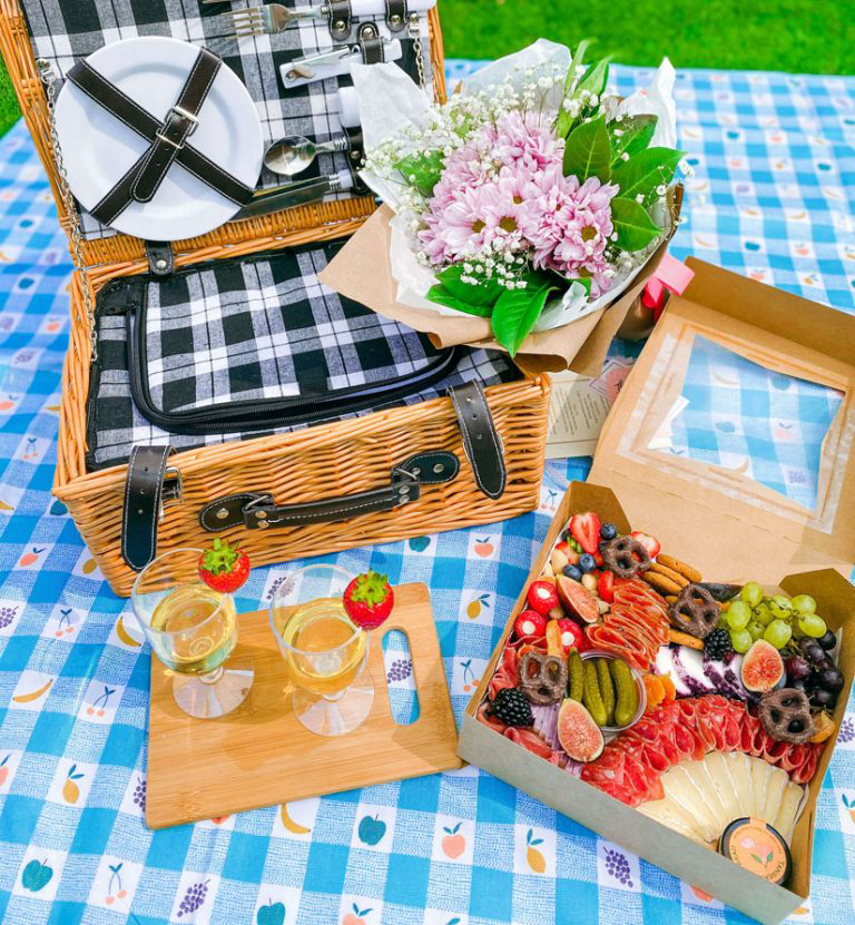 A picnic setting featuring food from Bijou Baskets.