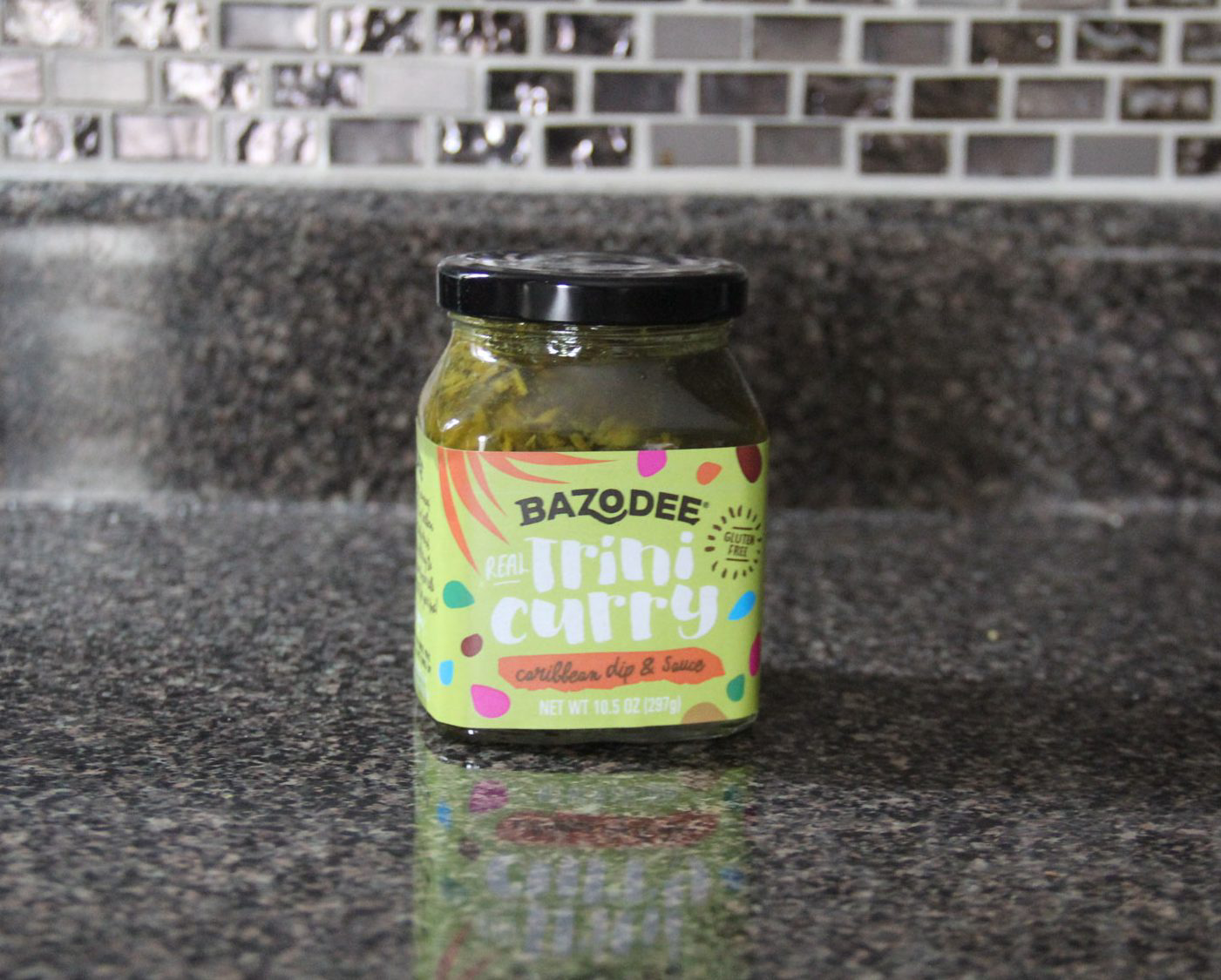 A full jar of Bazodee Caribbean dip and sauce.