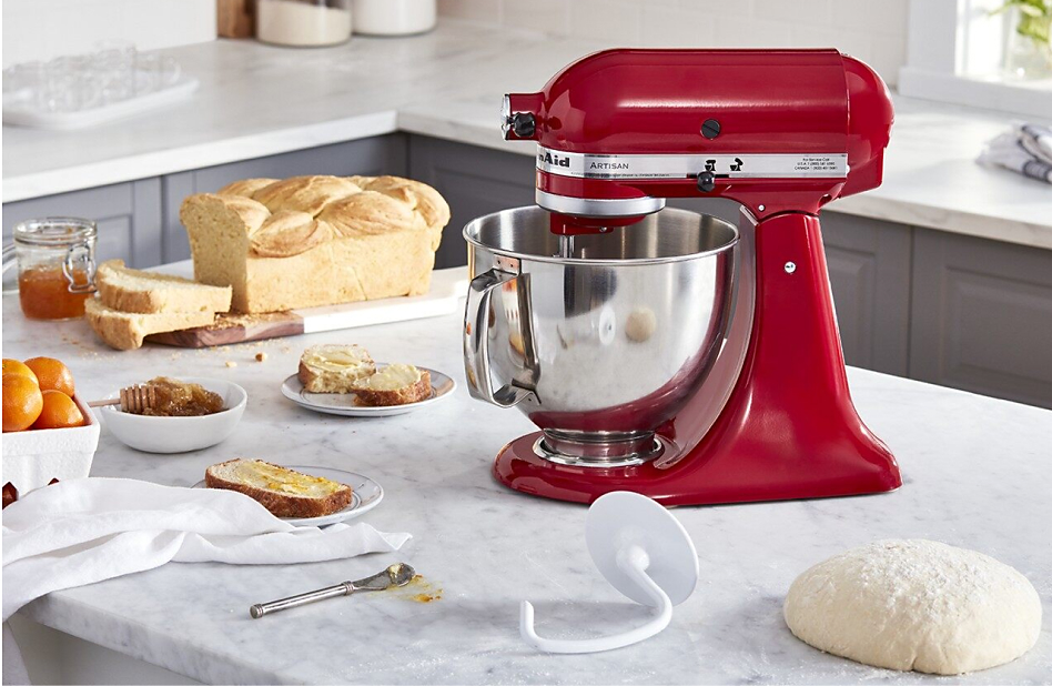 KitchenAid® stand mixer on countertop with dough hook, bread dough and homemade bread.
