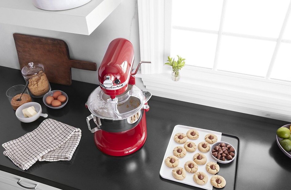 KitchenAid® stand mixer on countertop with plate of homemade cookies.