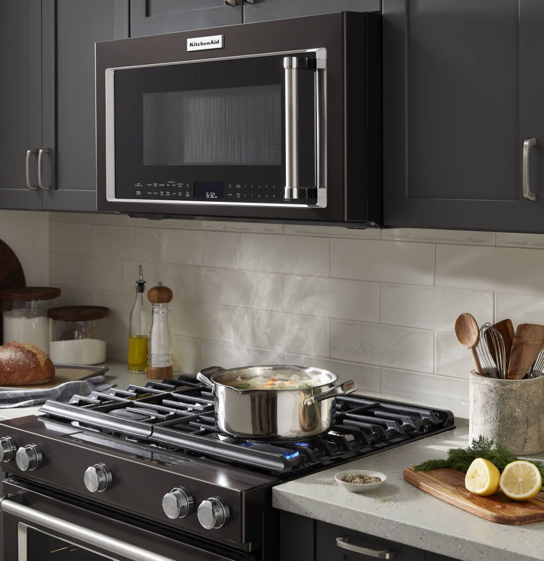 Black microwave hood combination in a black kitchen