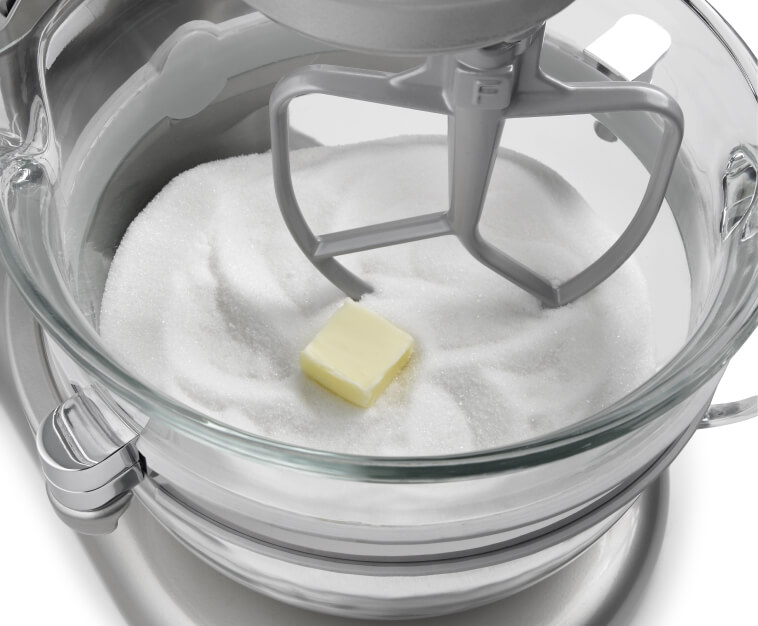 A stand mixer with butter and sugar