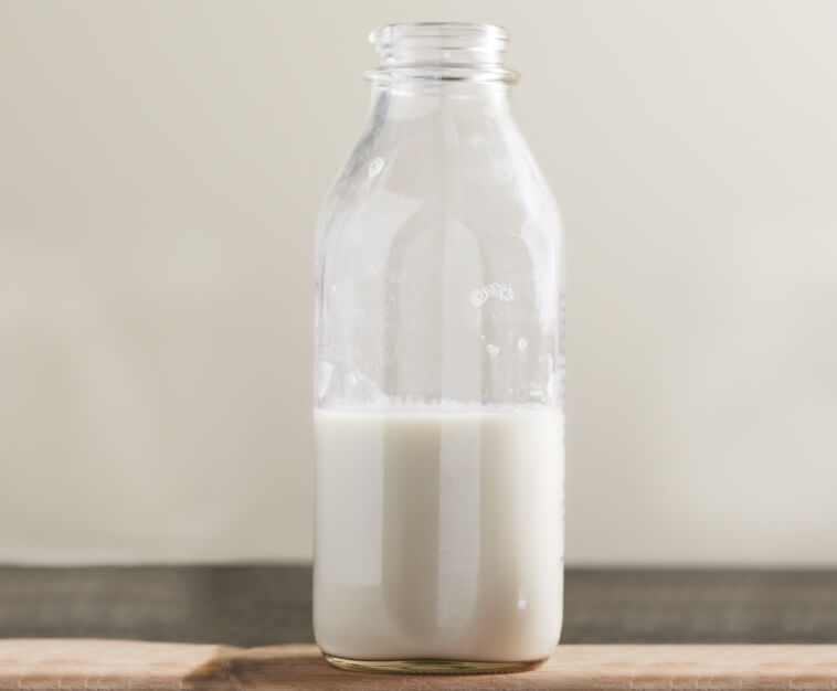 A half-full bottle of milk
