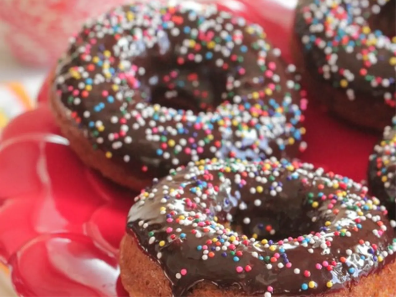 Banana doughnuts with chocolate frosting and rainbow sprinkles