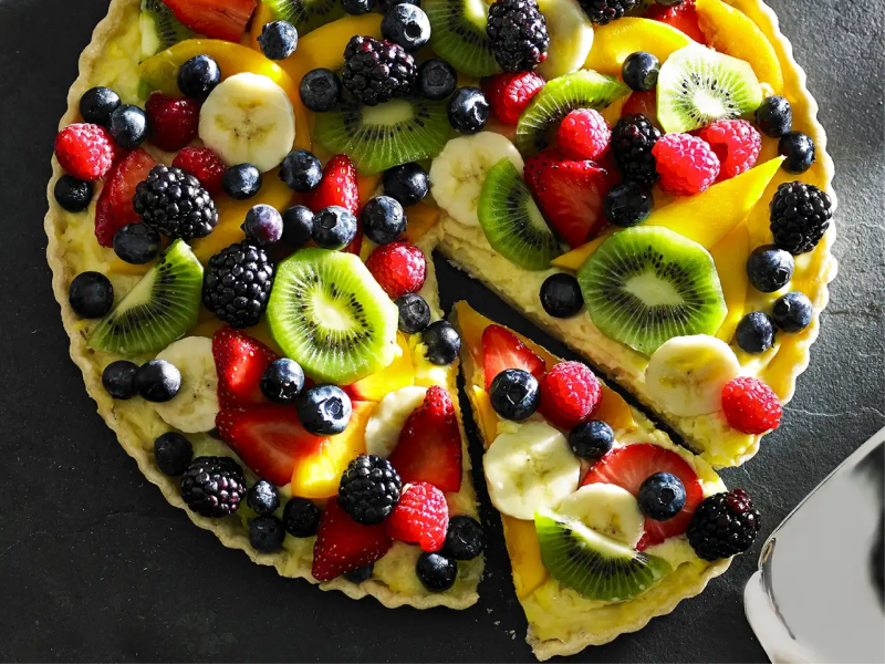 Fruit tart with berries and bananas layered on top