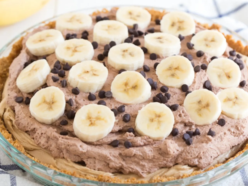 Chocolate banana peanut butter pie with bananas and chocolate chips on top