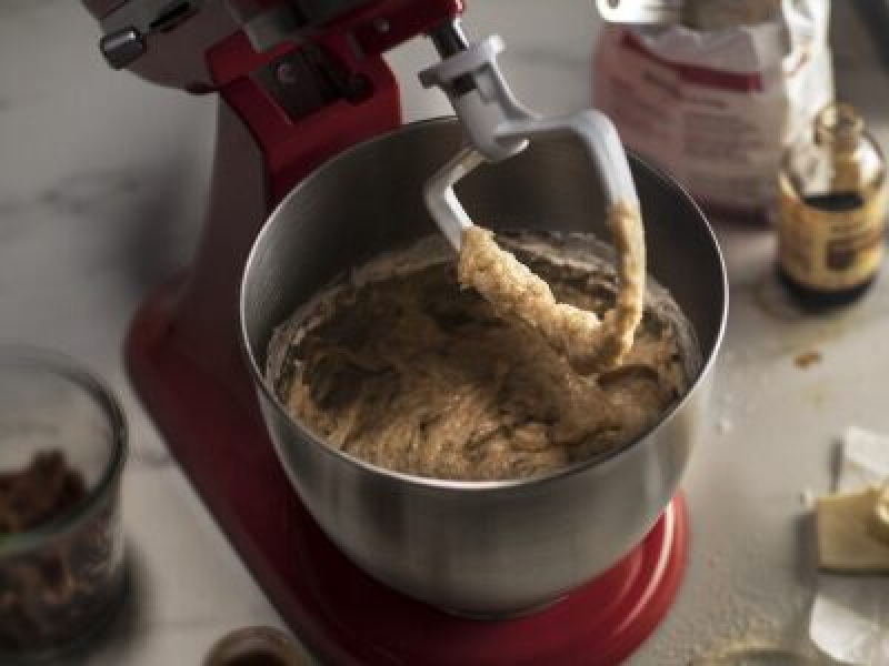 KitchenAid brand stand mixer with banana bread batter in the bowl