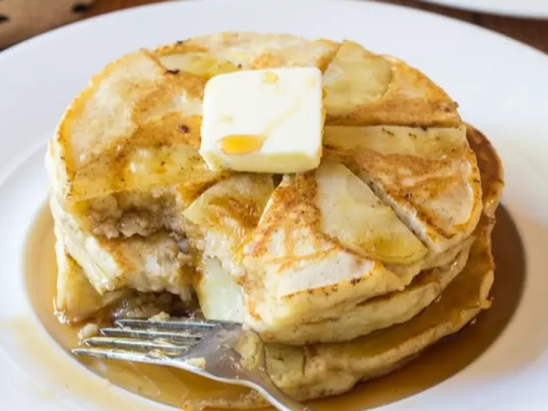Apple ricotta pancakes topped with butter and syrup