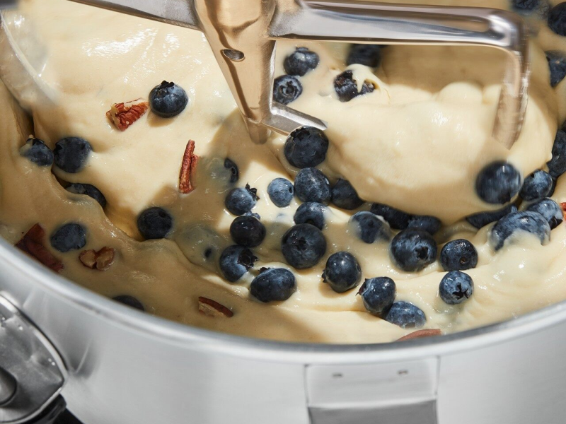 Nuts and blueberries mixing in quick bread batter