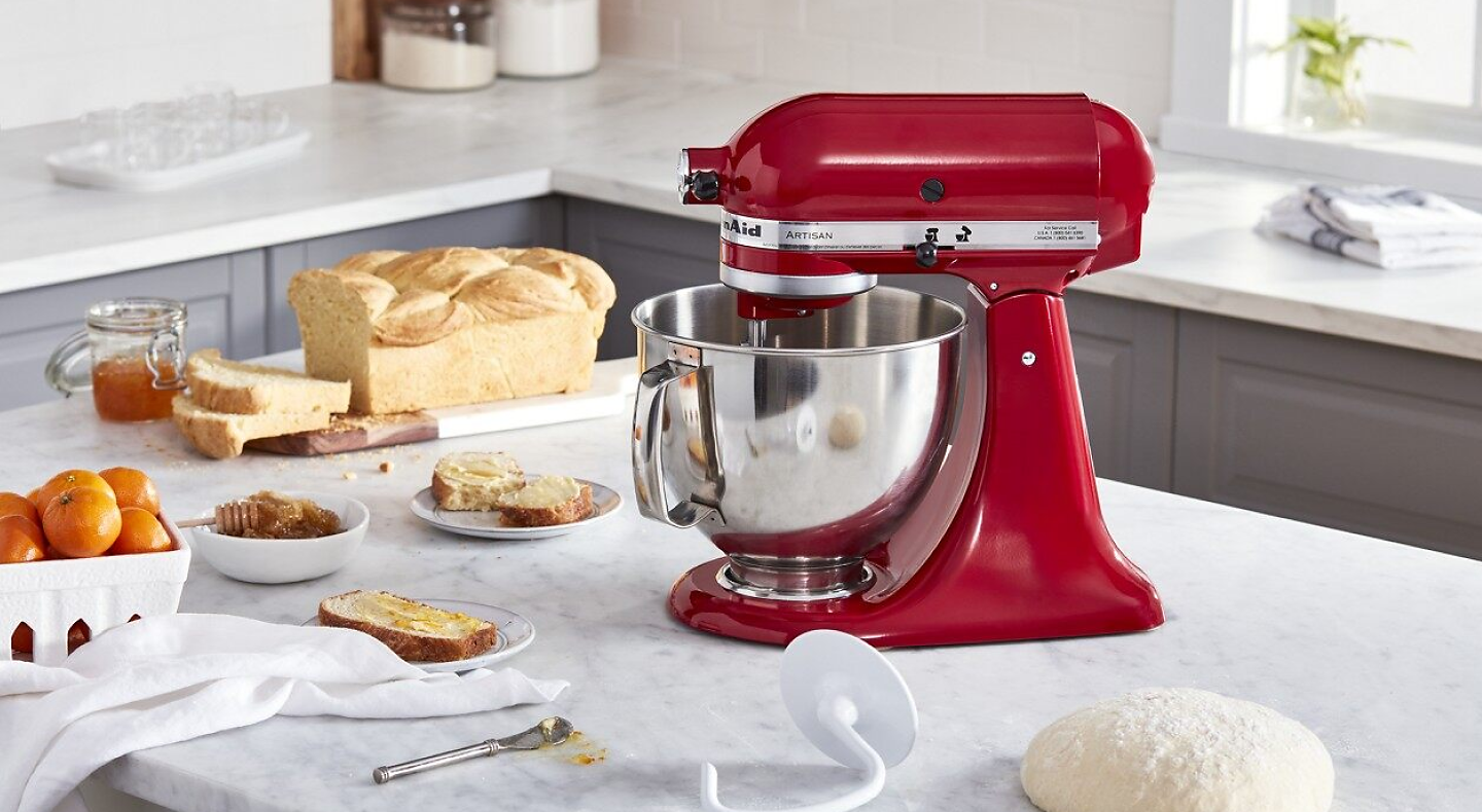 Red KitchenAid® stand mixer next to baking ingredients