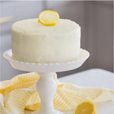A mini lemon cake with a slice of lemon.