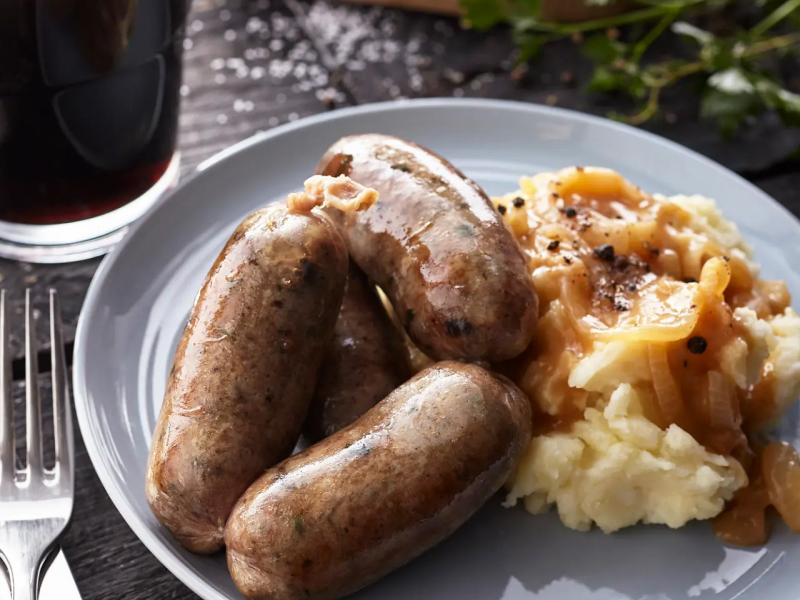 Sausage and mashed potatoes covered with gravy 