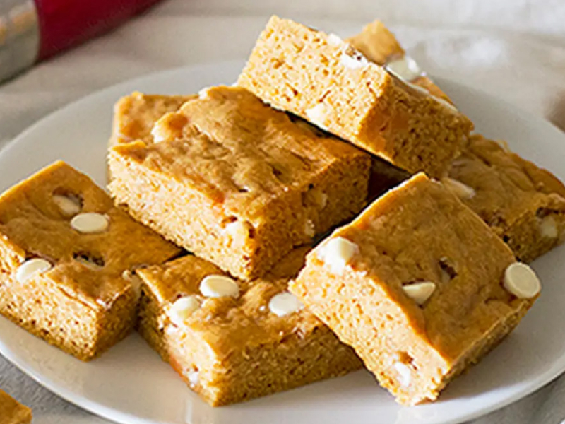 Sweet potato blondies with white chocolate chips on white plate
