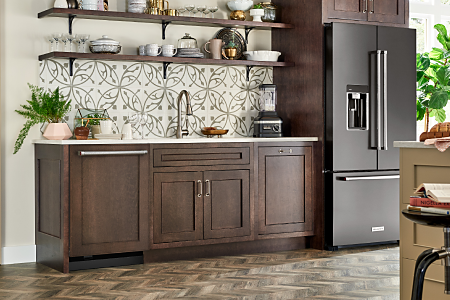A KitchenAid® refrigerator with a sleek black finish in a modern kitchen