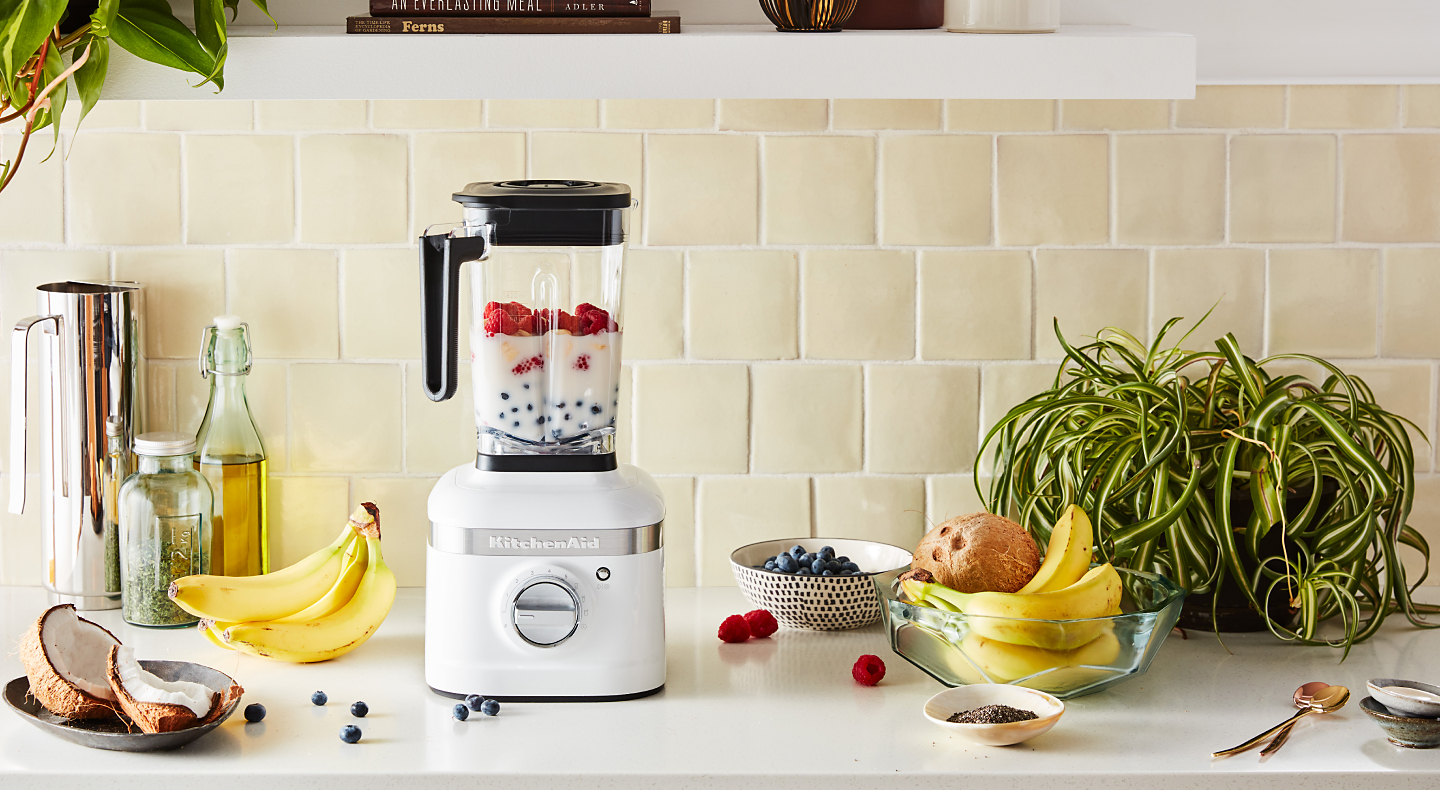 White KitchenAid® blender filled with milk and mixed berries