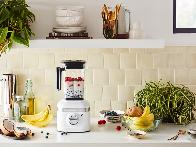 White KitchenAid® blender filled with milk and mixed berries
