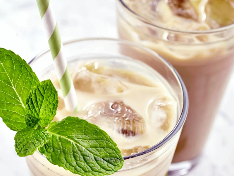 Glass of iced tea with cream and mint garnish