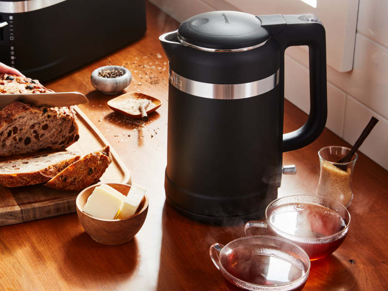Black KitchenAid® electric kettle next to sliced bread and butter