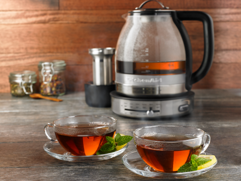 KitchenAid® electric kettle next to a cup of tea