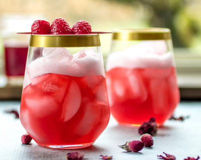 Raspberry rose cocktails in gold-rimmed glasses 