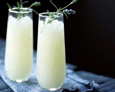 Tall flute glasses of ginger lavender infused vodka slush