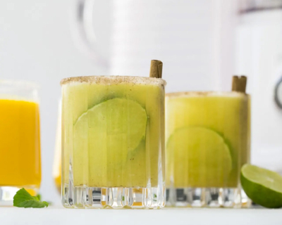 Glasses of freshly squeezed juice cocktails with lime rounds inside