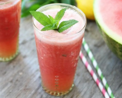 Watermelon lemon coconut drink in a glass garnished with mint leaves
